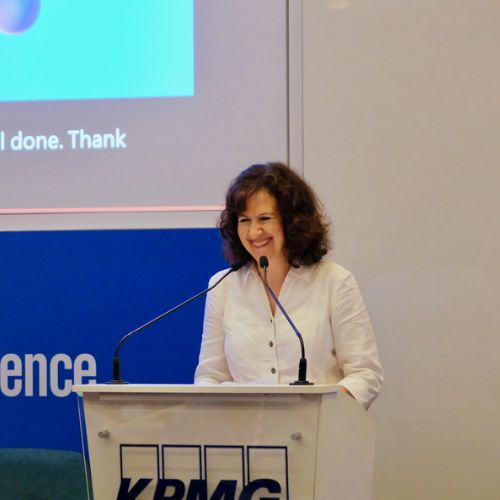 Jane Cordell smiles from a lecturn 